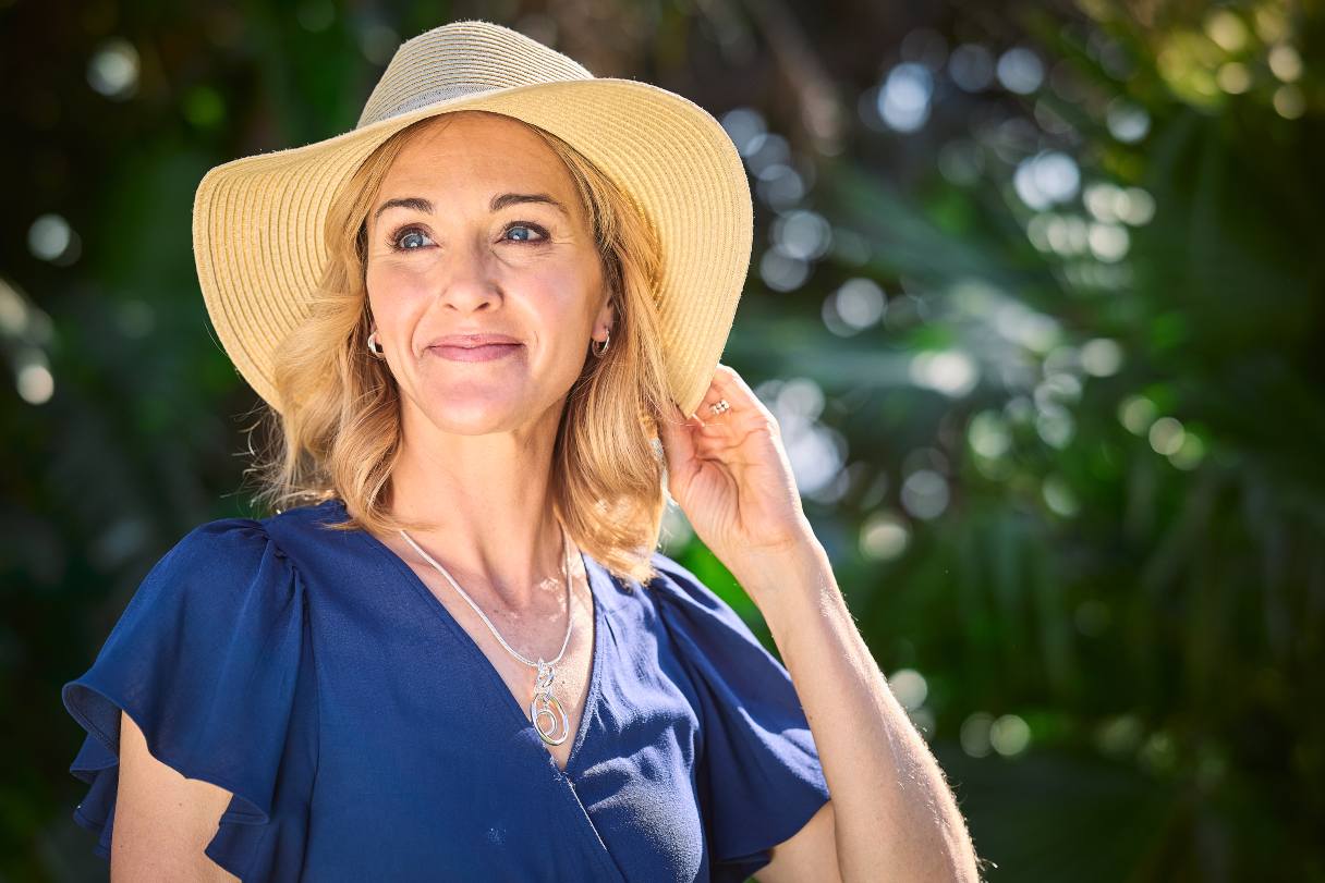 Women wearing hat, smiling in the sunlight