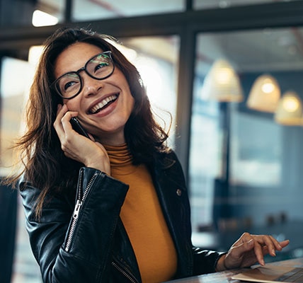 Woman smiling while talking on a mobile phone