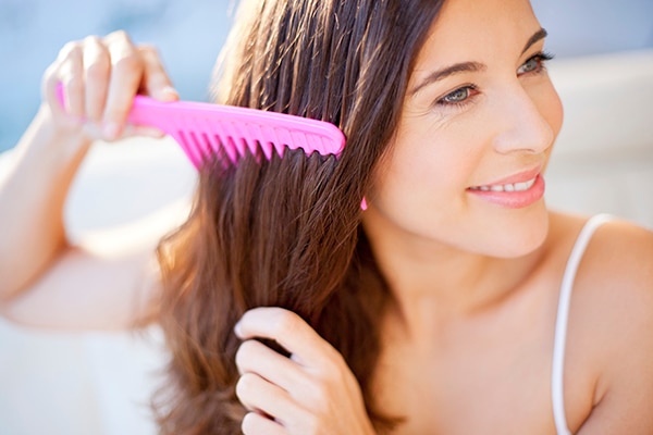 Woman combing hair