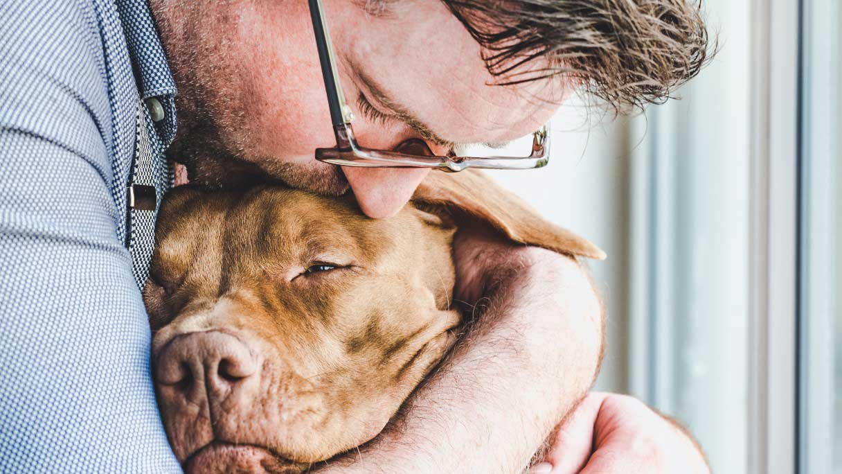 Man hugging dog