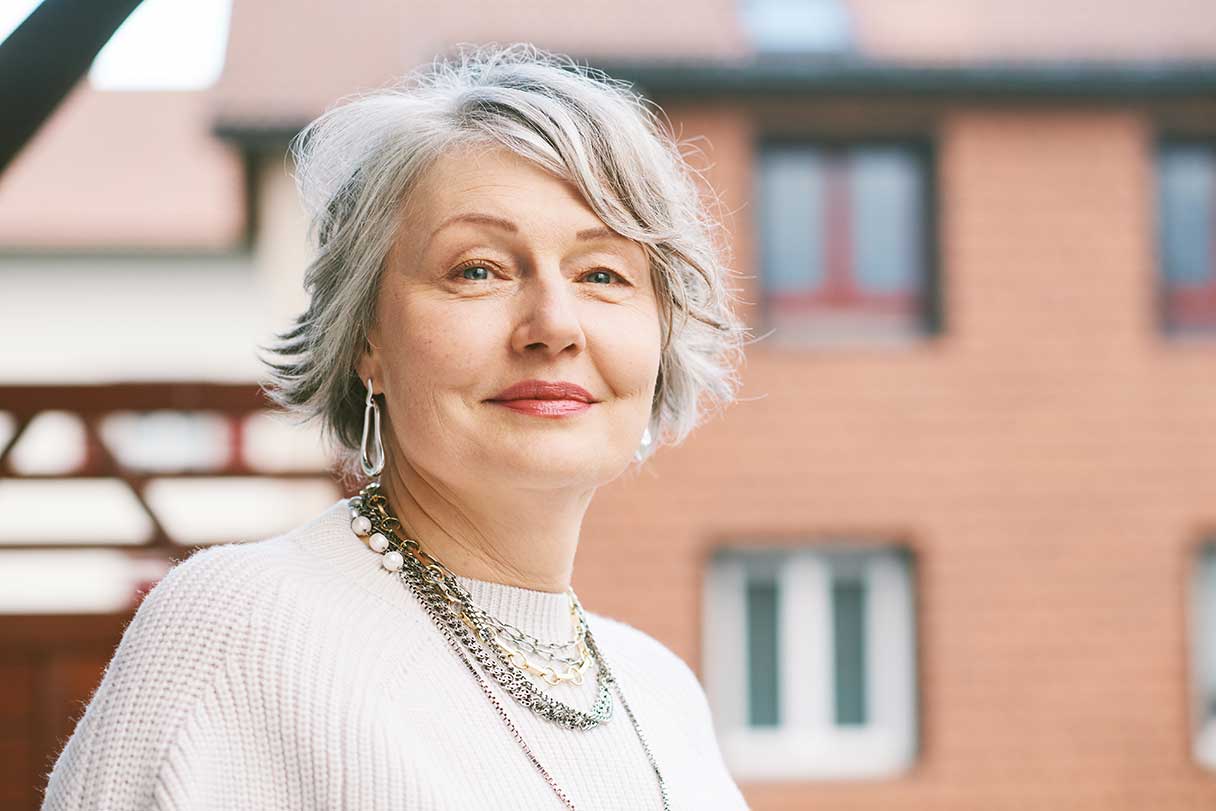 Close-up of senior woman in a white shirt