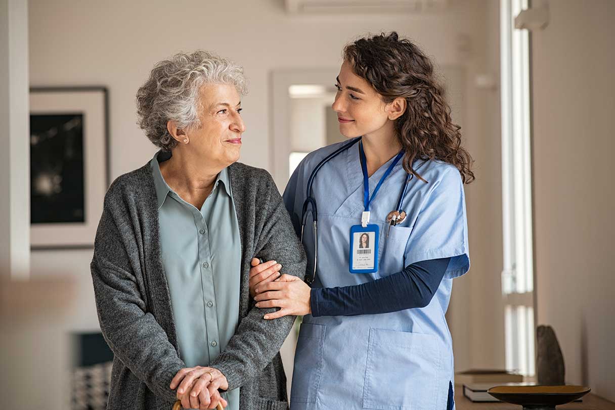 Nurse walking with an elderly woman