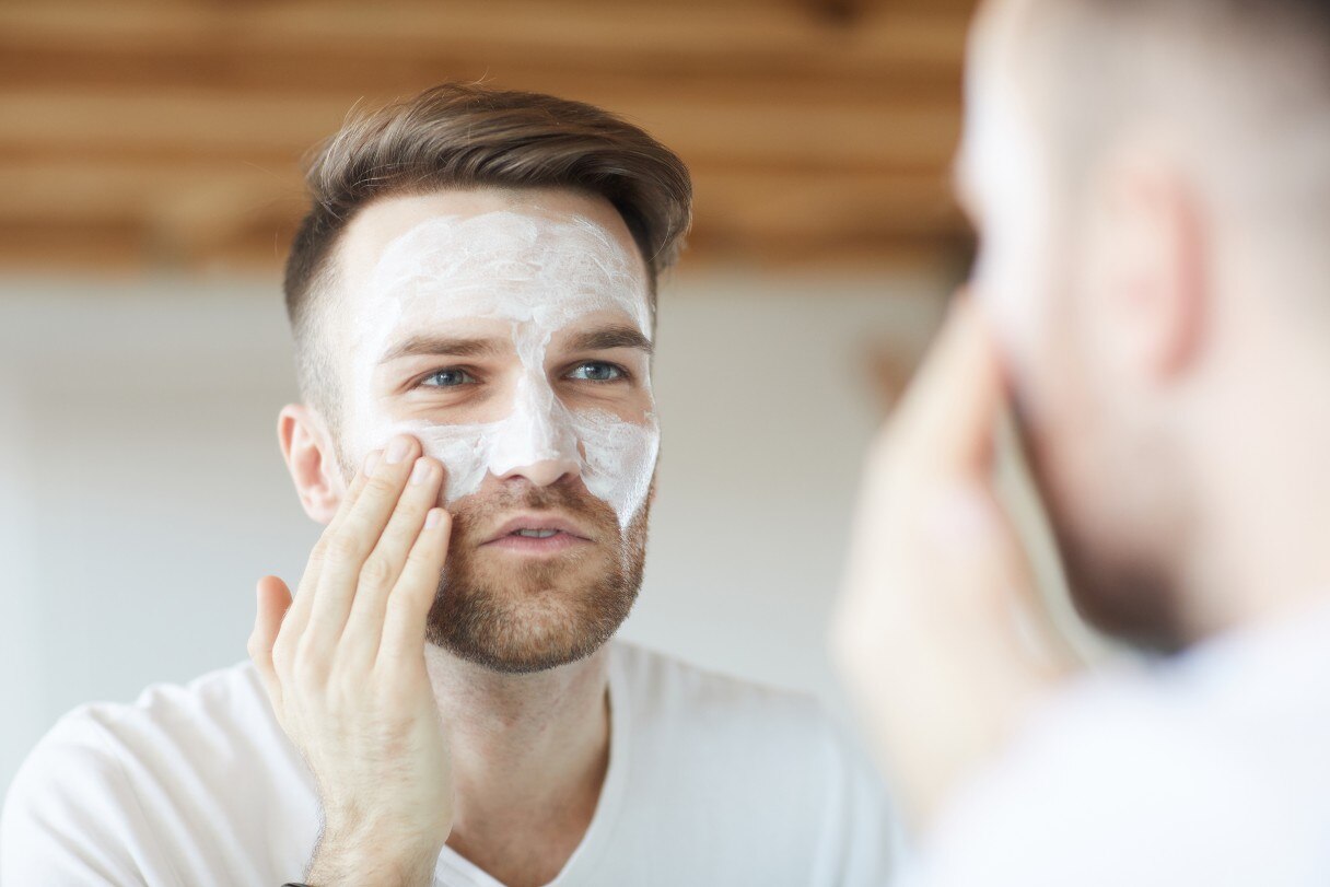 Man applying cream to his face