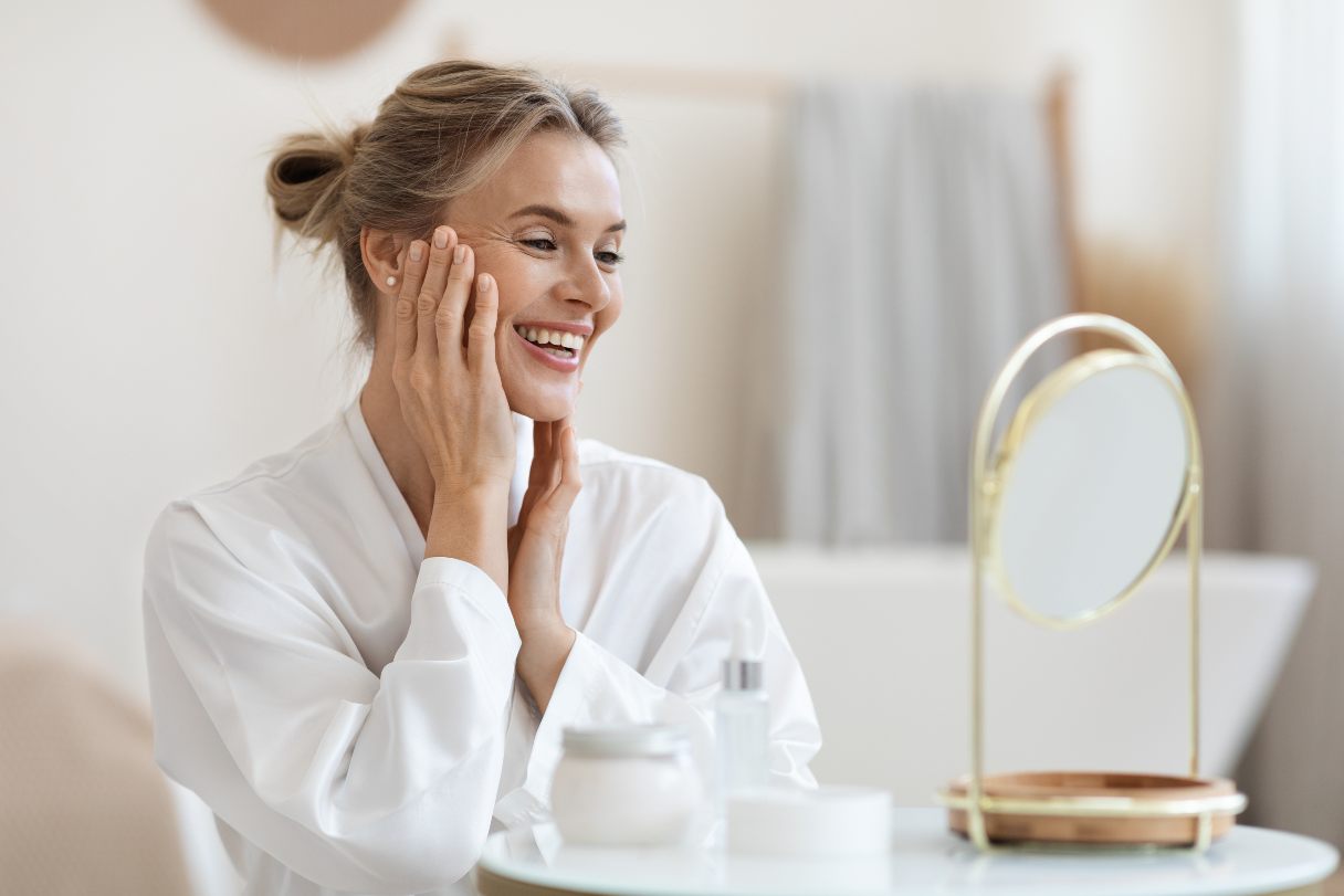 Smiling woman looking at herself in mirror