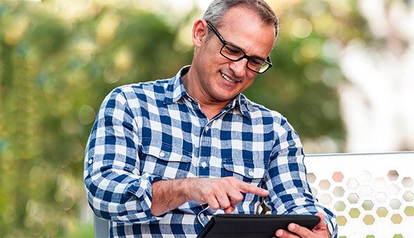 Man in glasses working on tablet