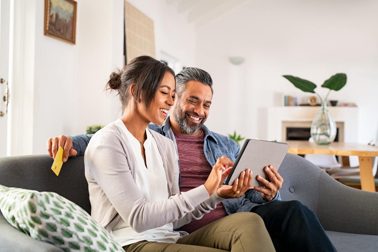 Couple on sofa looking at tablet