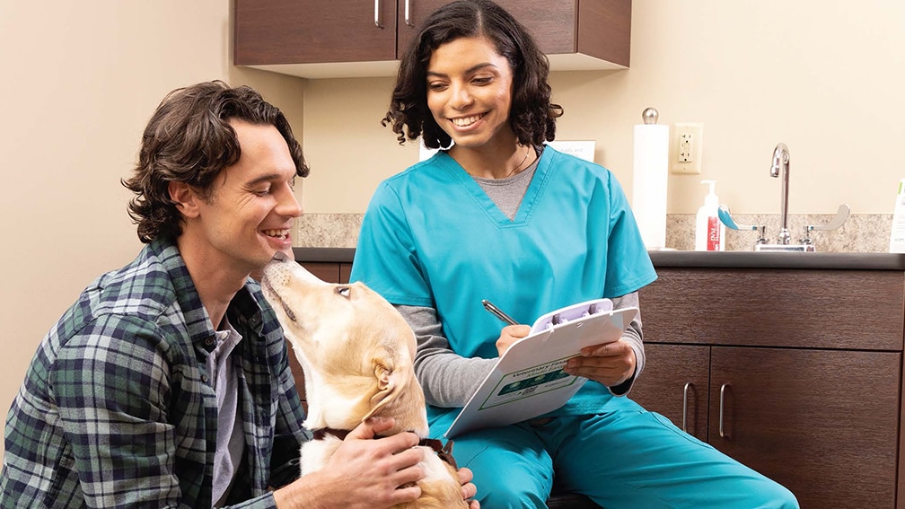 Man with dog at vet appointment