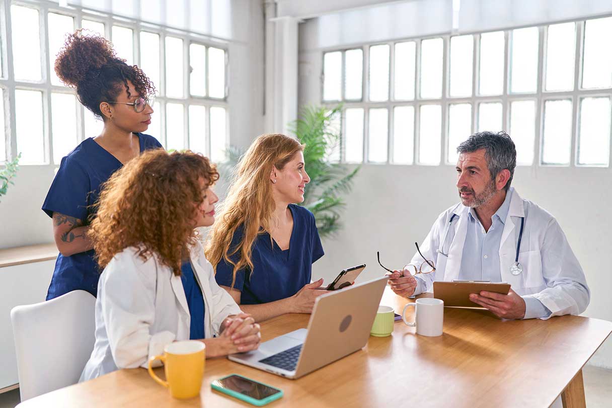 Healthcare professionals sitting at conference table