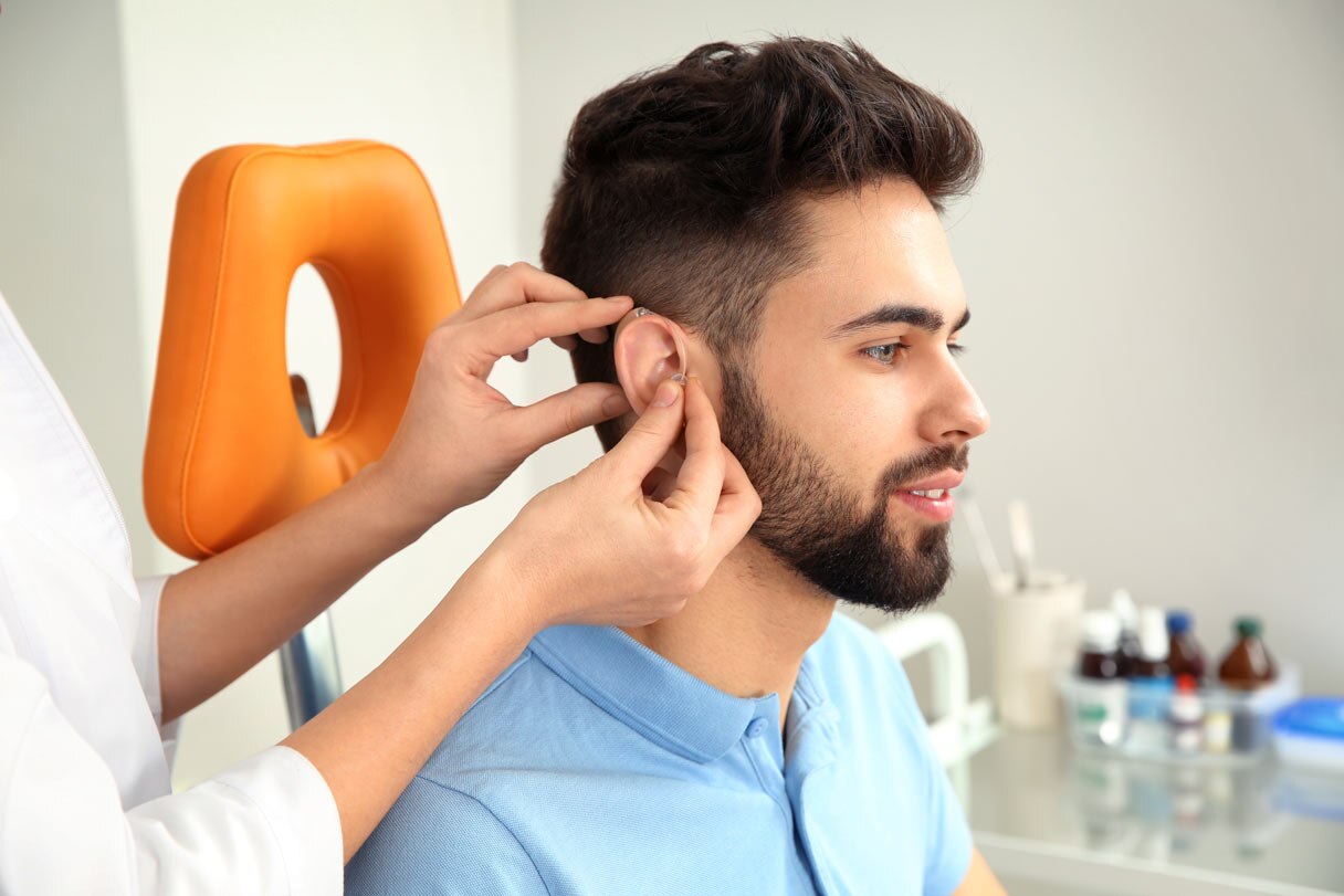 Man being fitted with hearing aid