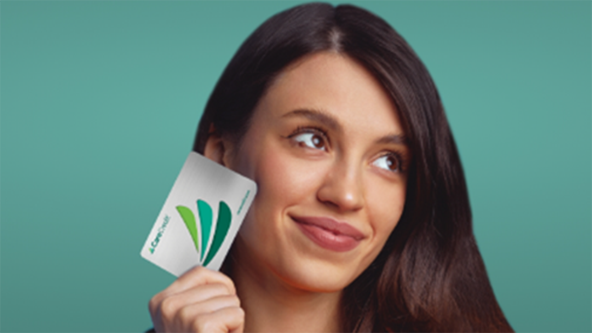 Woman holding a credit card up to her face