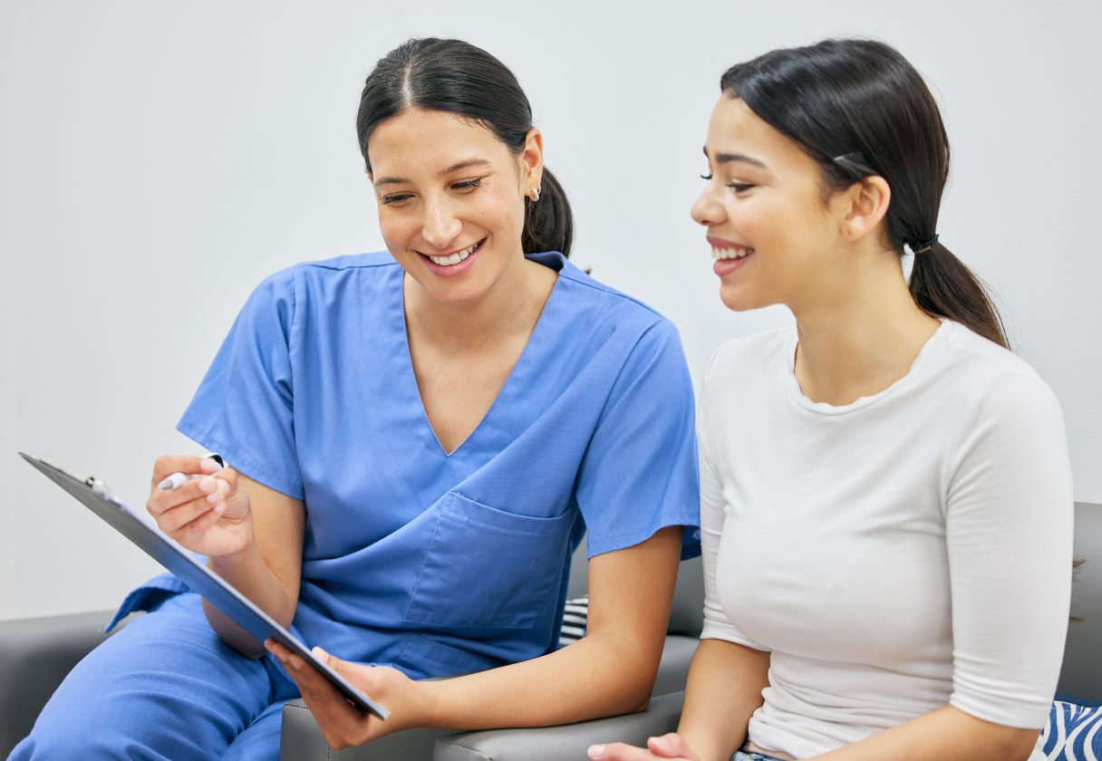 Dental professional showing patient a clipboard