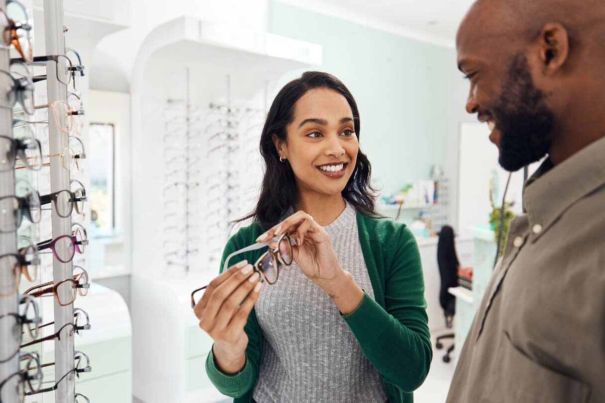 Man and woman looking at glasses in eyewear store