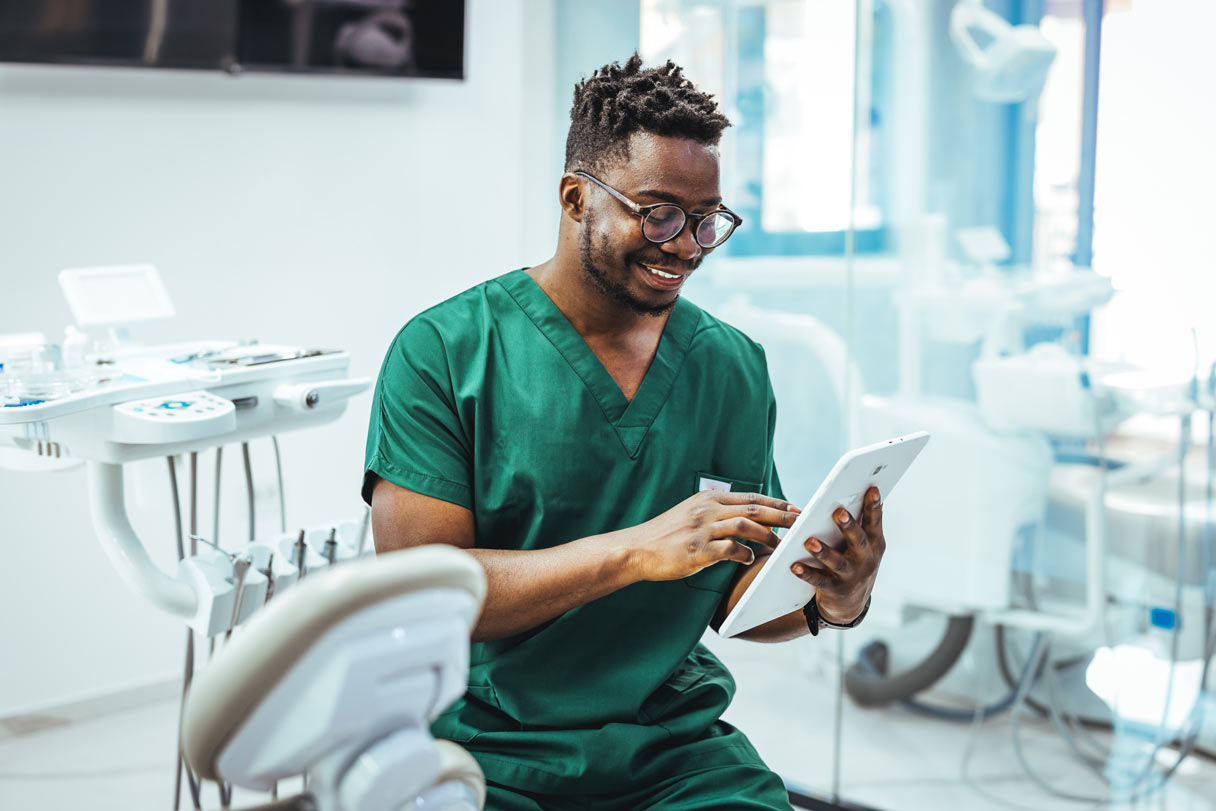 Dental team member looking at tablet device