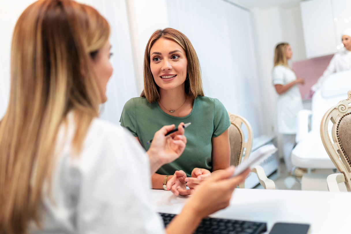 Receptionist speaking with patient