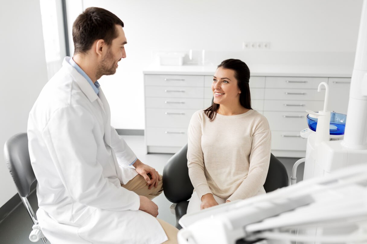 Dentist speaking with patient
