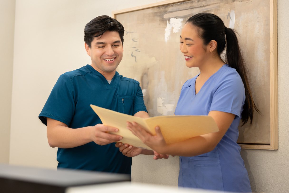 Two healthcare professionals looking at a file