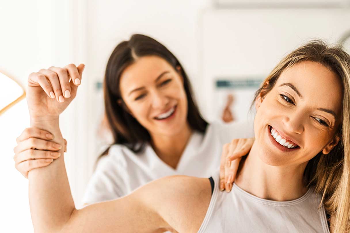 Chiropractor stretching woman's shoulder