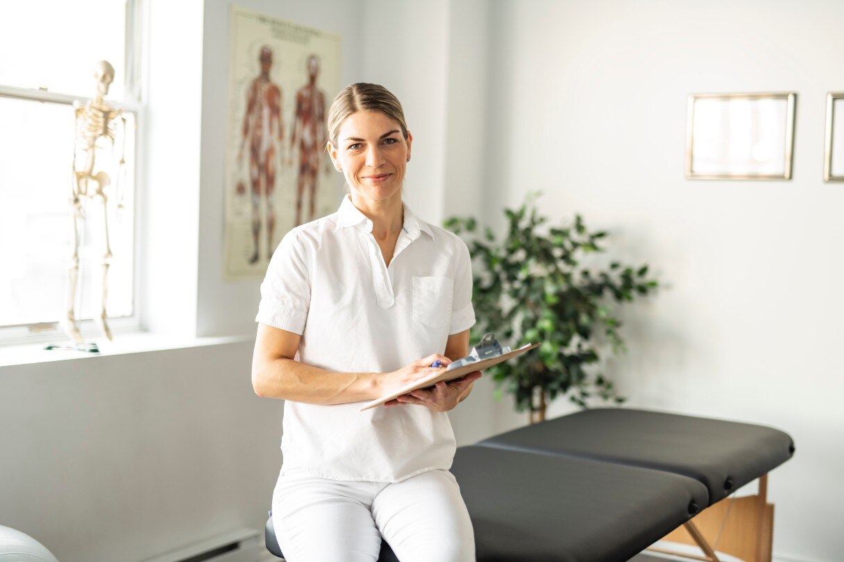 Chiropractor sitting on chiropractic table