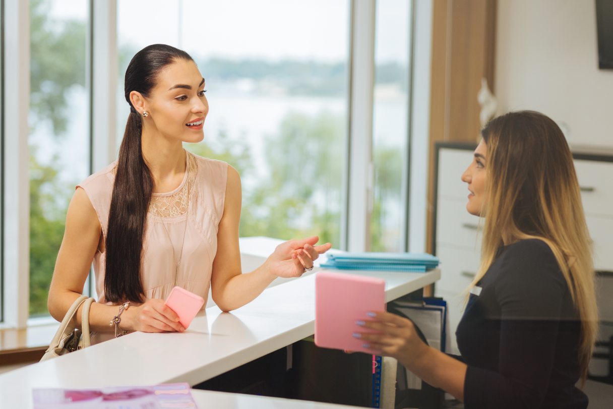 Woman speaking with receptionist
