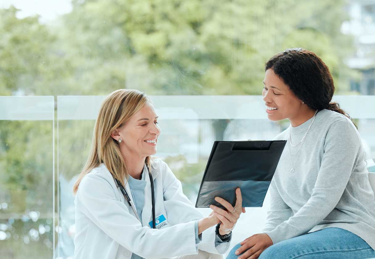 Provider showing woman a clipboard