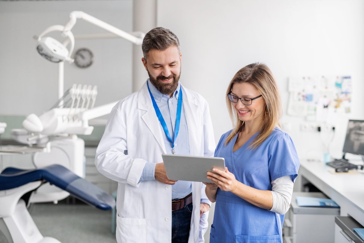 Dentist speaking with dental hygenist
