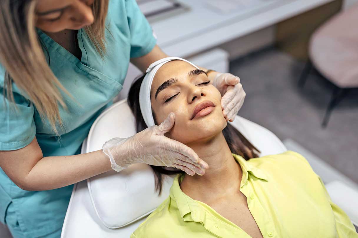 Woman receiving facial service