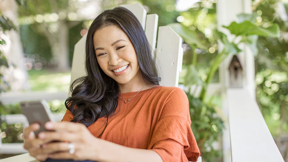 Woman smiling at her phone