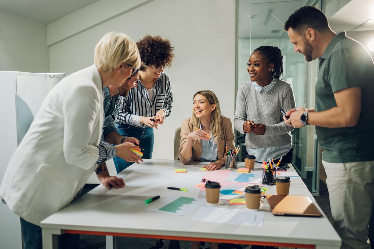 Group of medical professionals, meeting at conference table with coffees