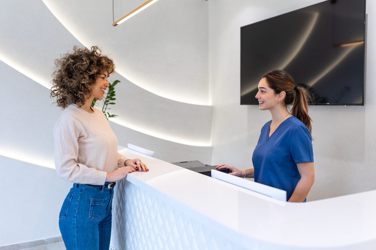Receptionist speaking with patient