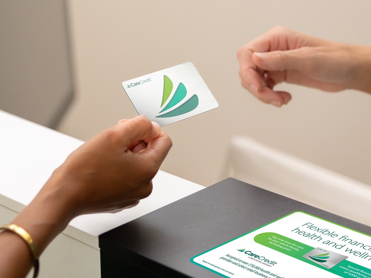 Health system staff helping patient with CareCredit financing