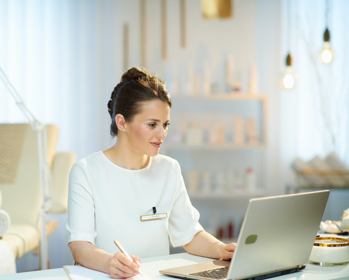 Receptionist working on laptop