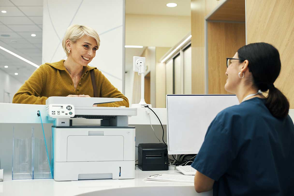 Receptionist speaking with patient