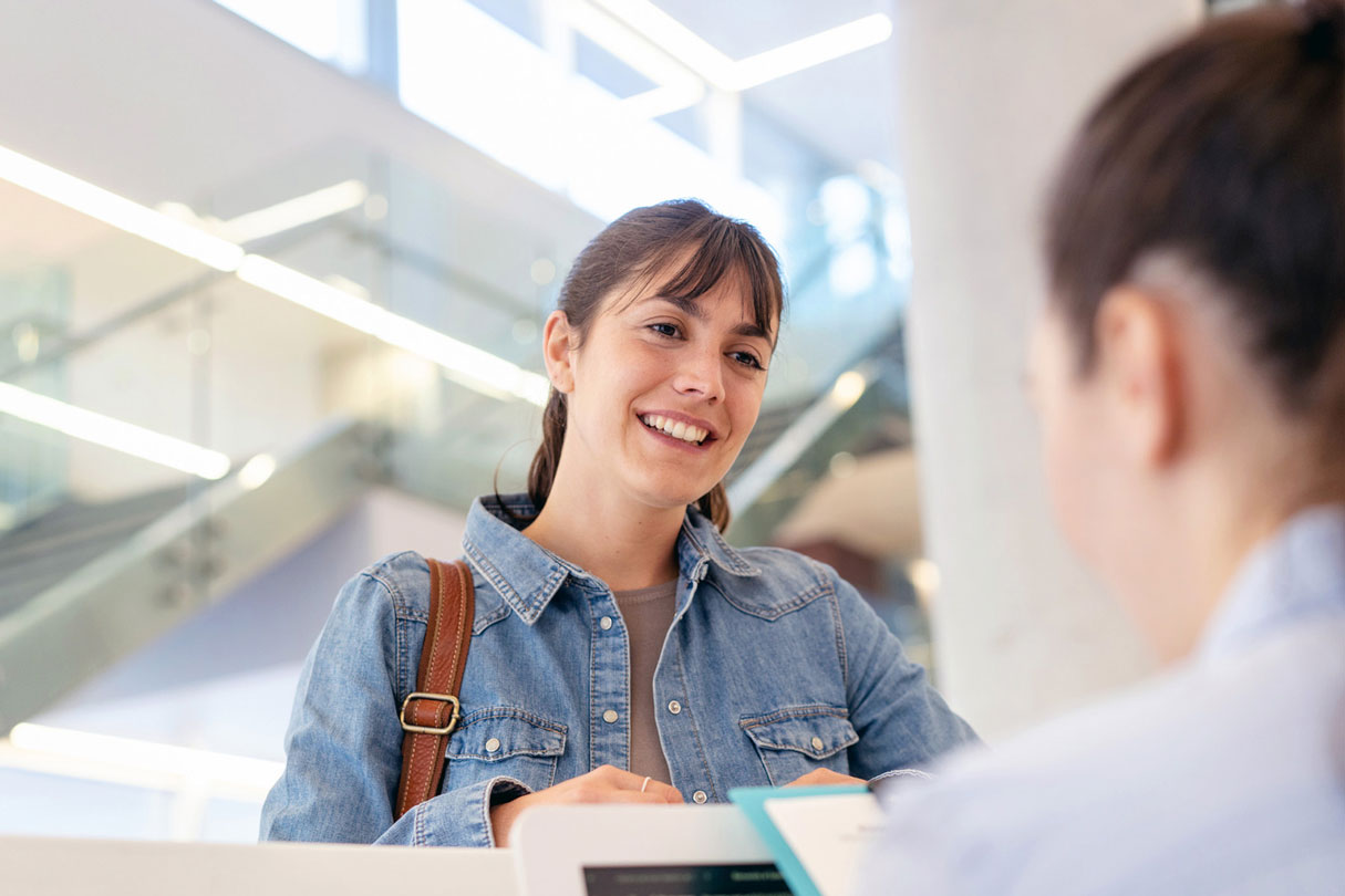 Woman speaking with receptionist
