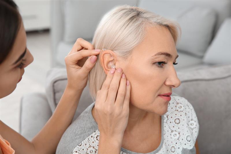 Woman being fitted with hearing aid