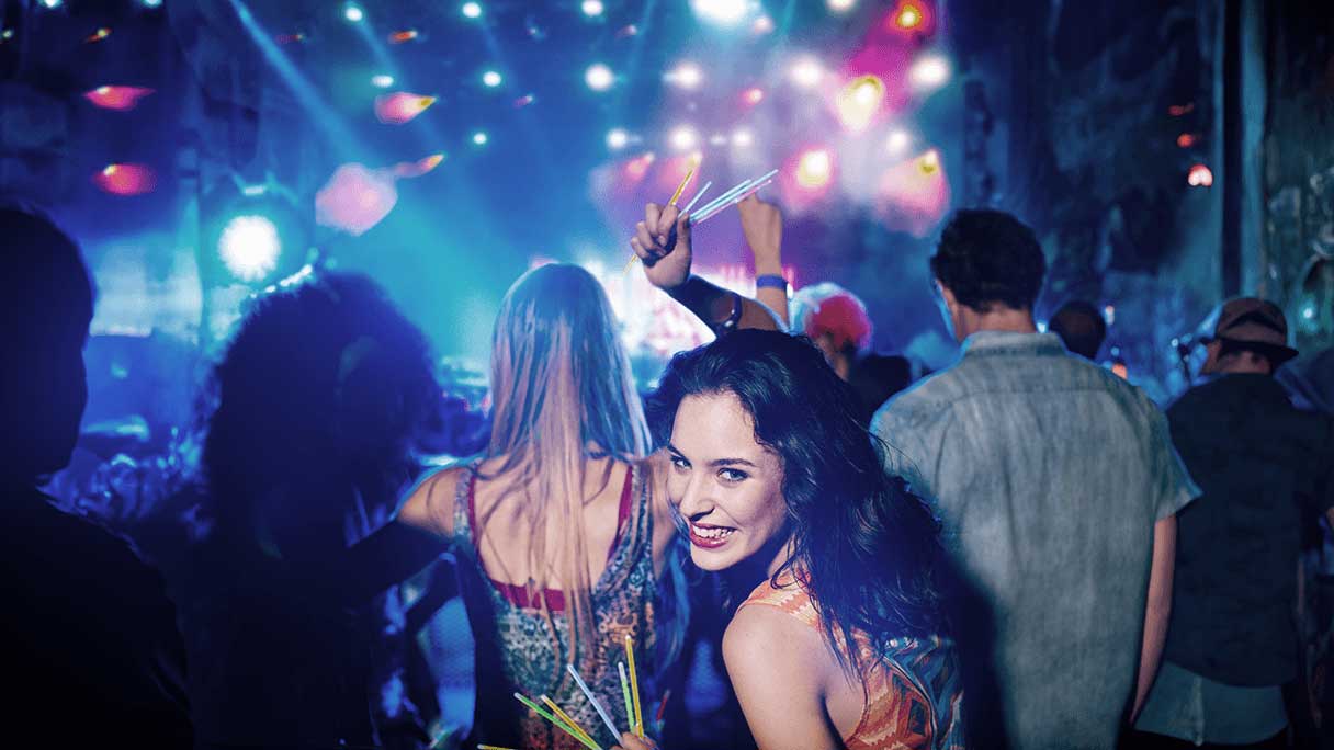 Woman standing in front of crowd at concert