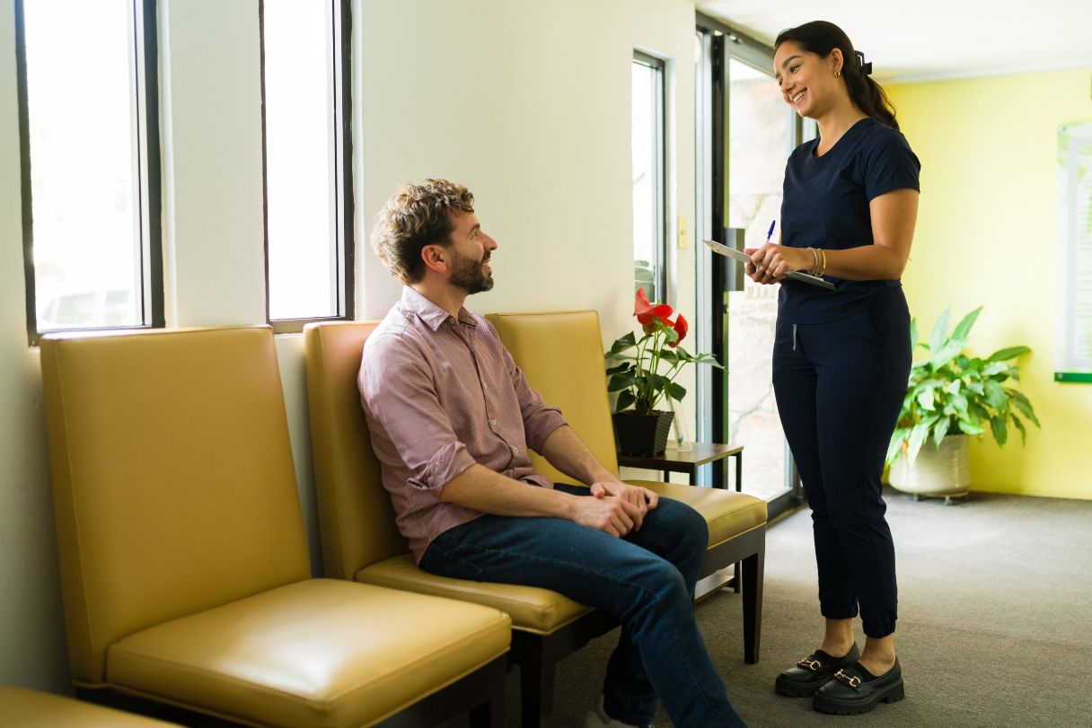 Healthcare professional speaking with patient