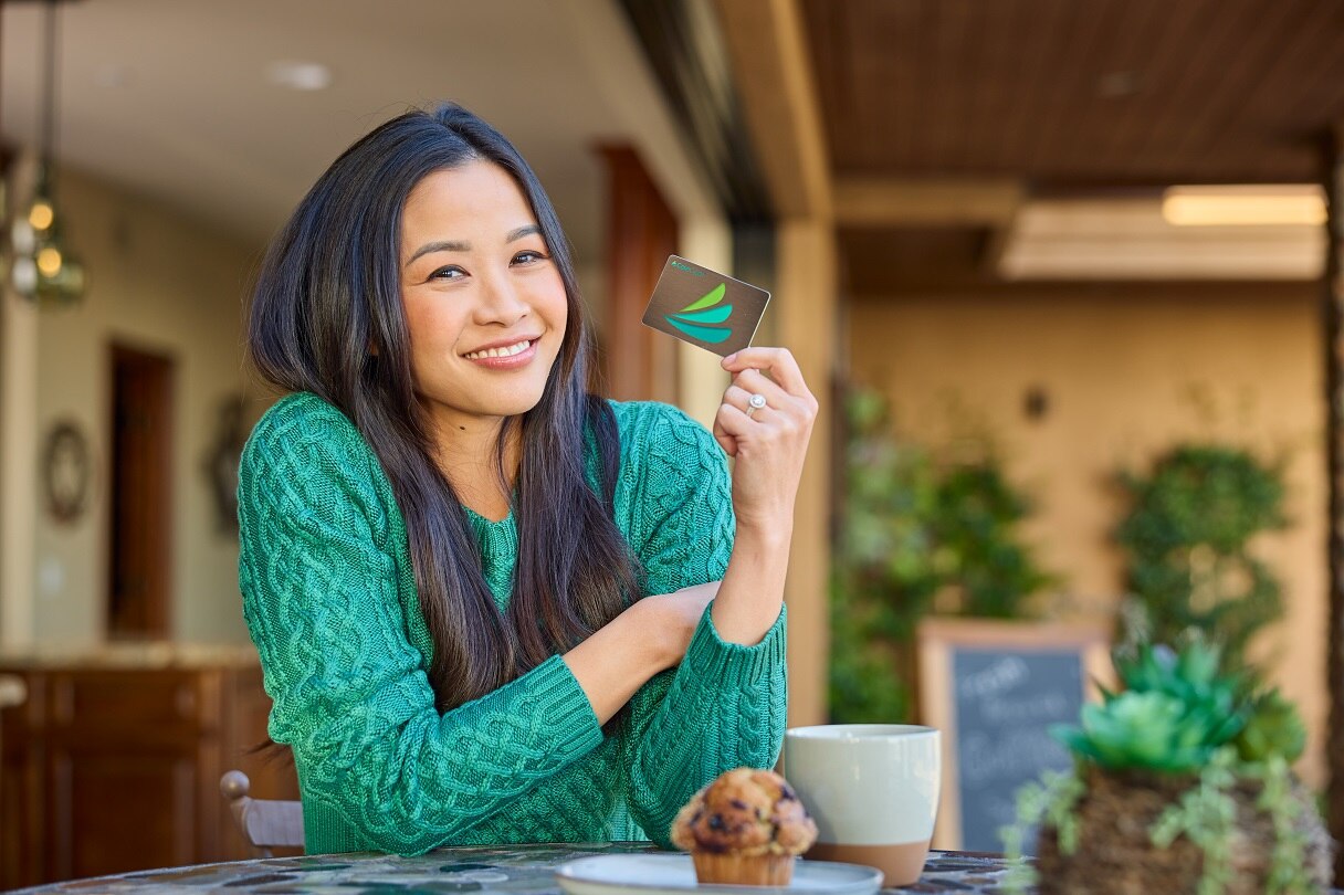 Smiling woman holding CareCredit credit card