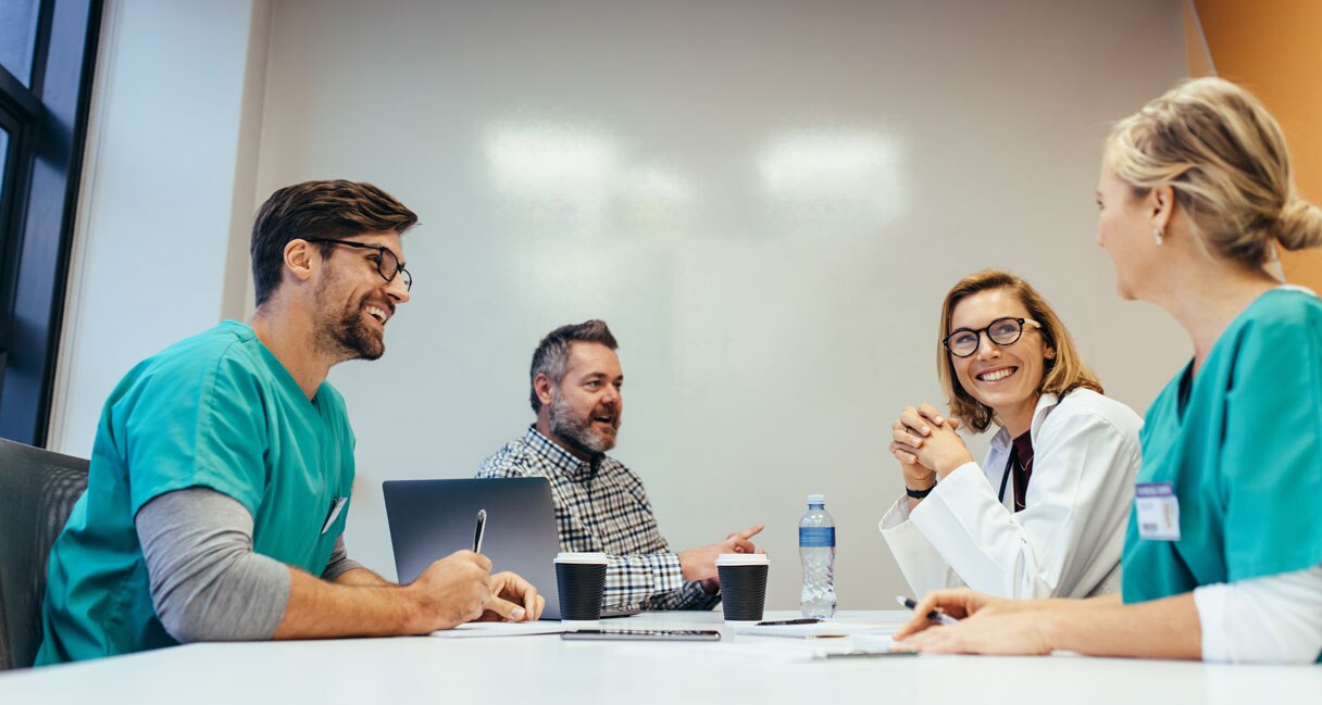 Medical professionals sitting at conference table