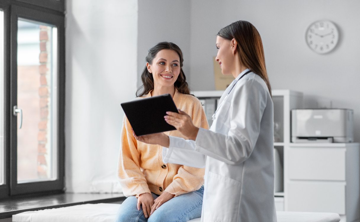 Medical professional showing patient a tablet screen
