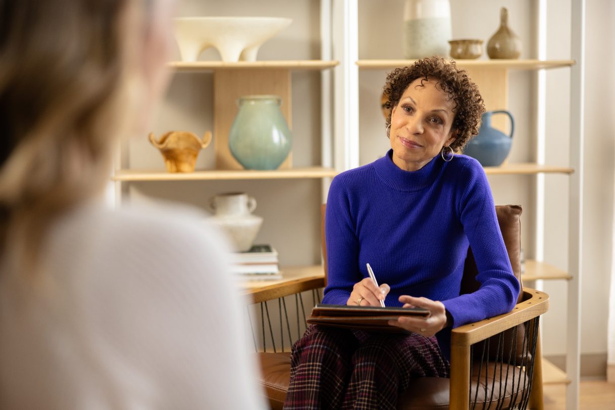 Mental health professional speaking with client