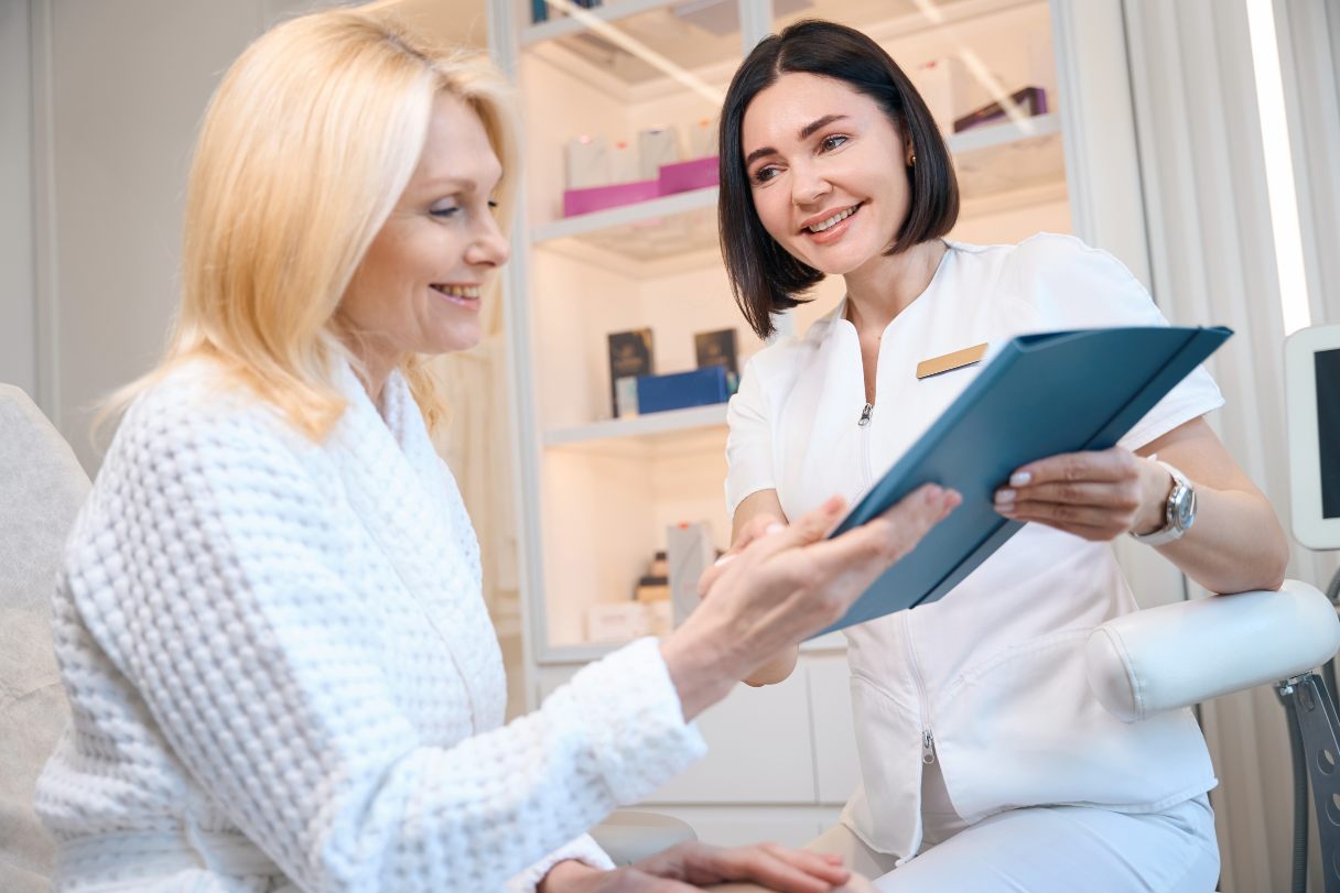 Cosmetic professional showing woman a clipboard