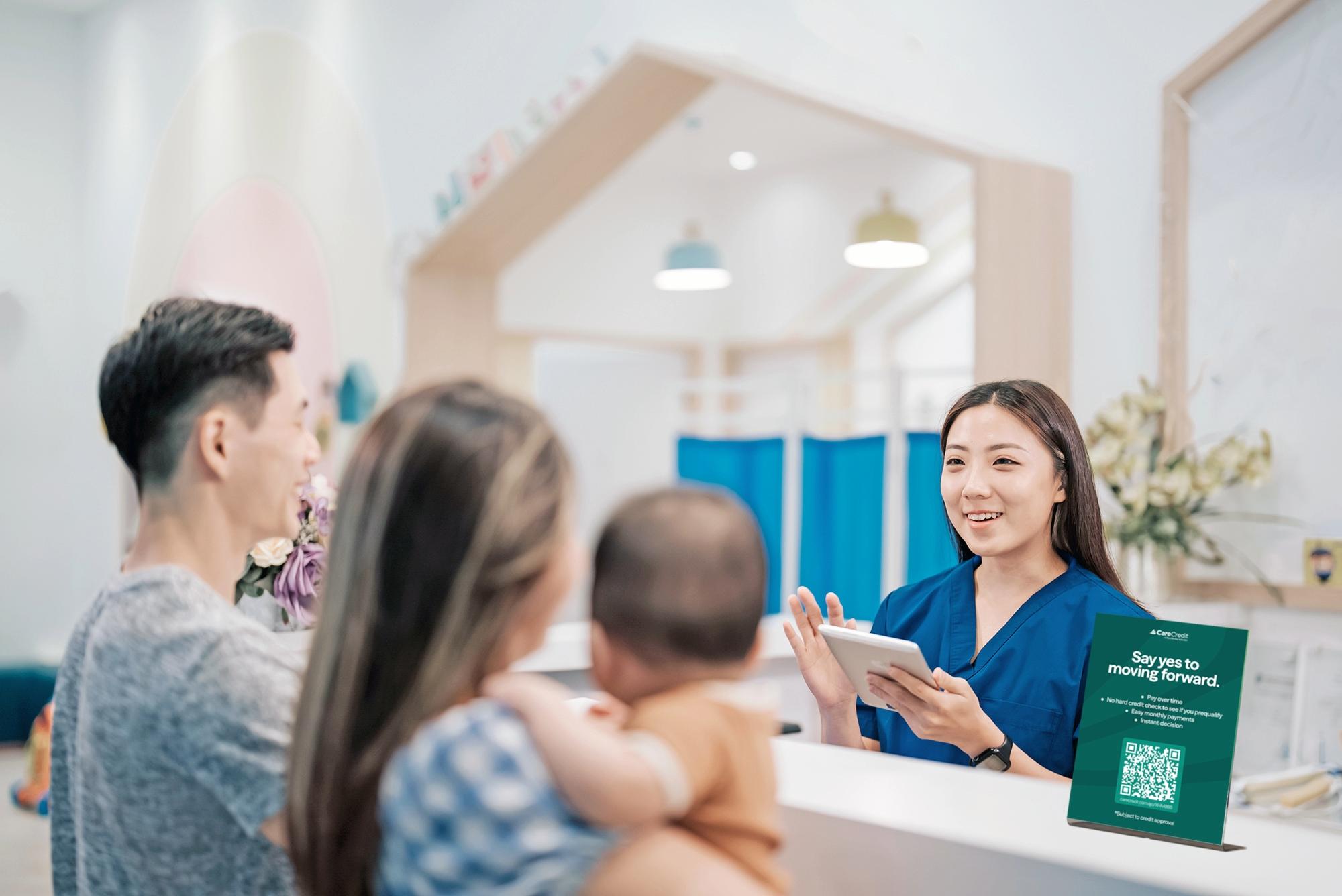 Healthcare receptionist speaking with family