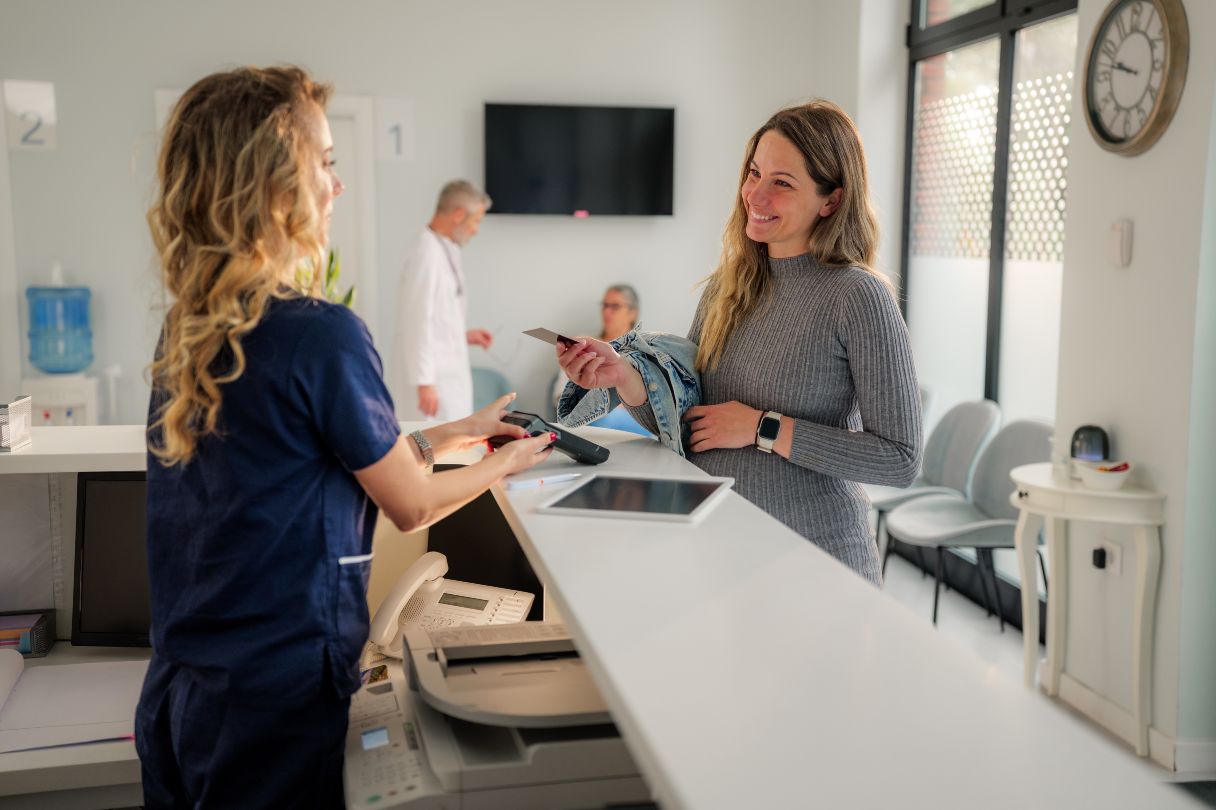 Receptionist speaking with patient