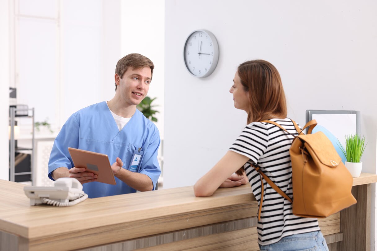 Receptionist speaking with patient