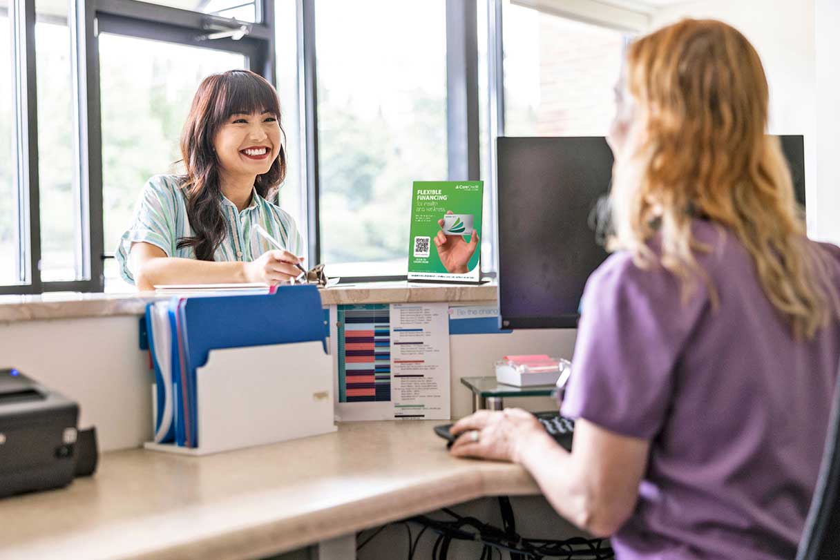 Woman speaking with healthcare receptionist