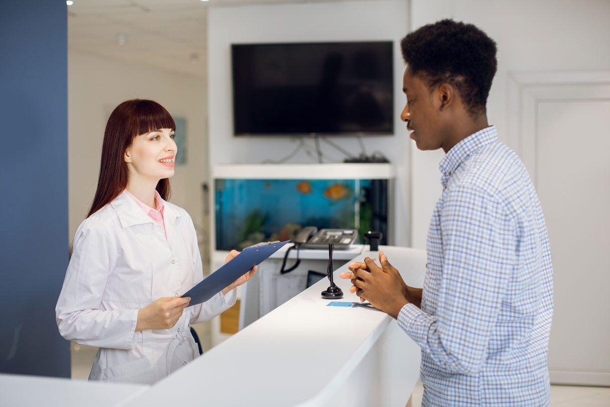 Receptionist speaking with patient