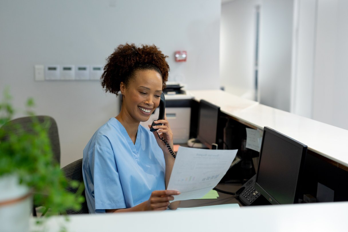 Dental receptionist speaking on phone