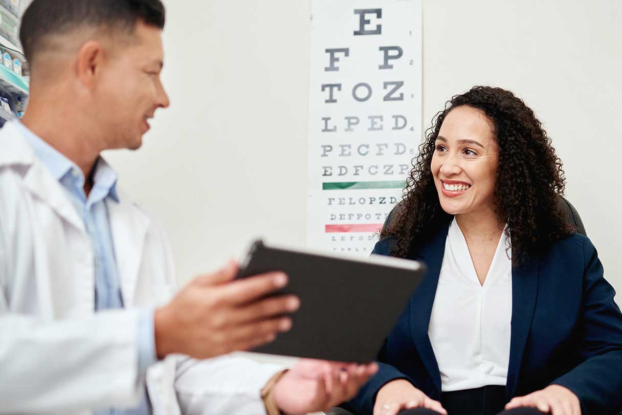 Optometrist showing a patient a tablet device