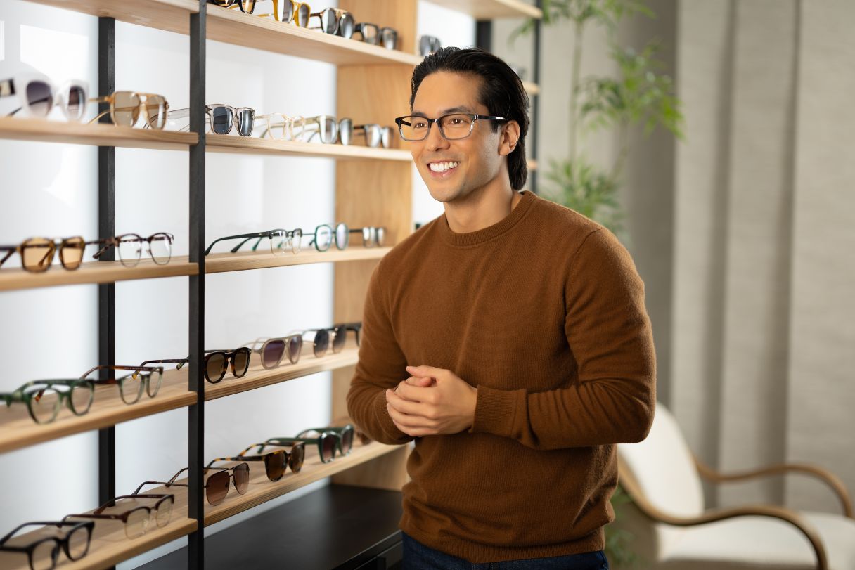 Man trying on eyeglasses in eyewear store
