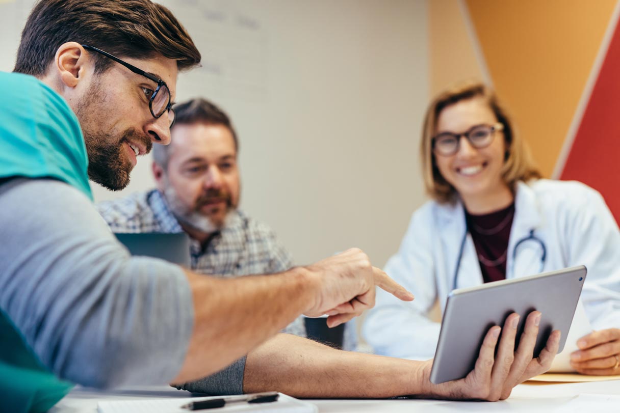 Healthcare professionals looking at tablet device